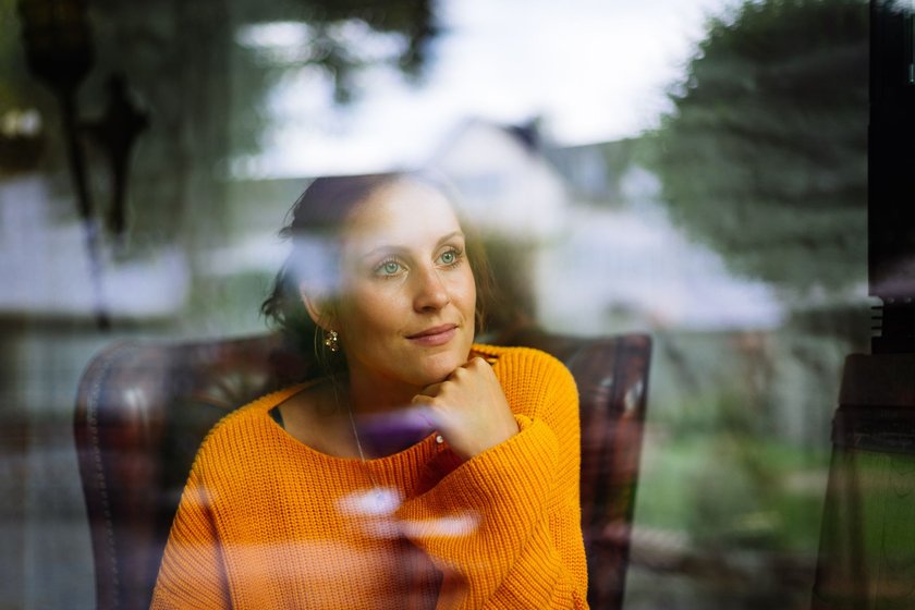 Tagträumende Frau starrt aus dem Fenster